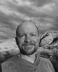 Photo of Lecturer Nathan Roberts, of the History Department, smiling