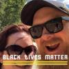 A selfie of Jesse Anarde and his wife smiling, with the text "Black Lives Matter" superimposed in yellow writing