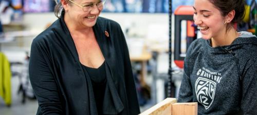 Professor Sarah Stroup laughing with student during STEM in the Ancient World class